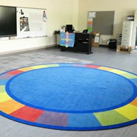 Class room with a large, colorful circular rug
