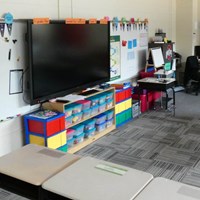 Classroom with cubbies and a large TV