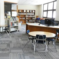 Classroom with chairs, tables, and bookshelves