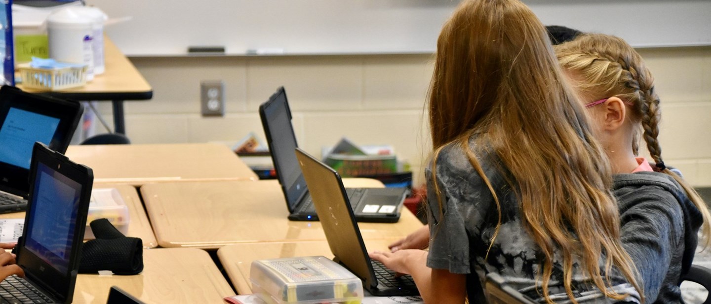Students reading on laptops